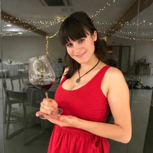 Lucy-in-red-dress-holding-a-glass-of-wine
